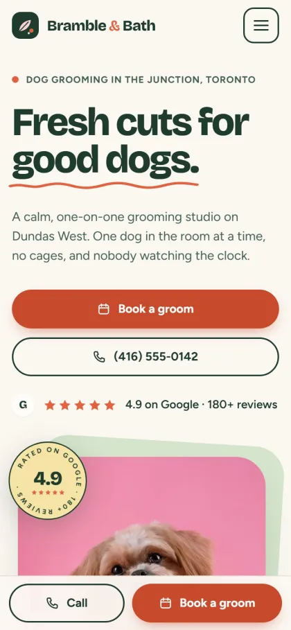 Bramble & Bath, a fictional dog groomer, on a phone.